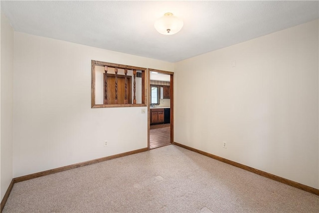 19 Cindy Ln, Coventry, RI 02816 - empty room featuring baseboards, light colored carpet, and a sink