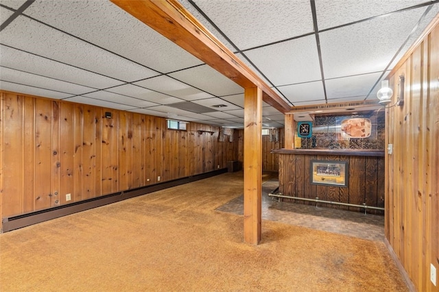 19 Cindy Ln, Coventry, RI 02816 - below grade area with wood walls, carpet floors, a drop ceiling, a bar, and a baseboard radiator