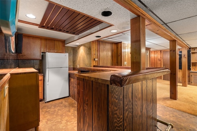 19 Cindy Ln, Coventry, RI 02816 - kitchen with freestanding refrigerator, brown cabinetry, a peninsula, recessed lighting, and custom exhaust hood