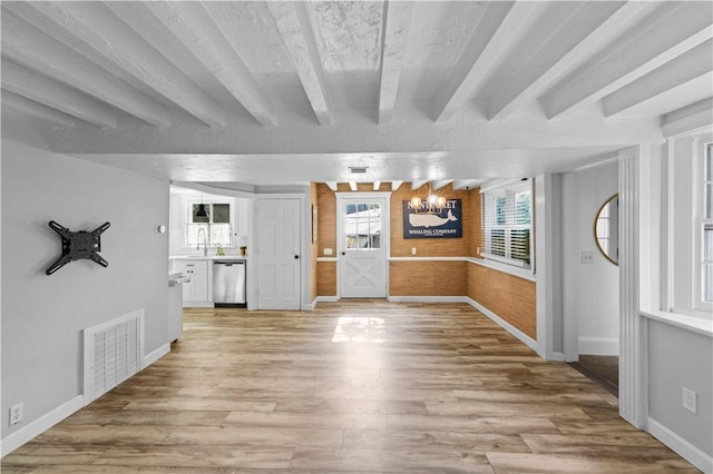 694 Windwood Dr Unit C, Tiverton, RI 02878 - unfurnished living room with light wood-type flooring, a chandelier, baseboards, beamed ceiling, and a sink