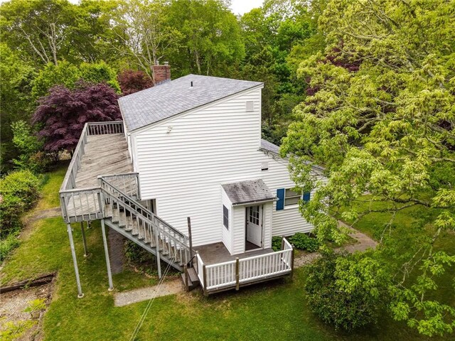 10 Joanth Ter, Westerly, RI 02891 - rear view of house featuring a wooden deck, stairway, a chimney, roof with shingles, and a lawn