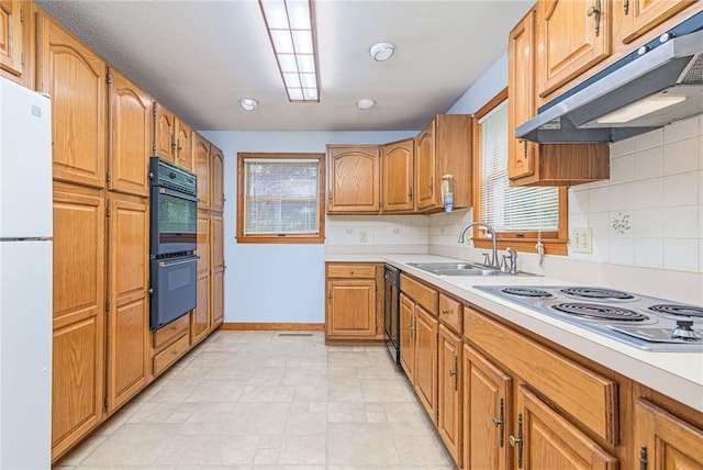 10 Joanth Ter, Westerly, RI 02891 - kitchen with under cabinet range hood, a sink, freestanding refrigerator, electric stovetop, and light countertops