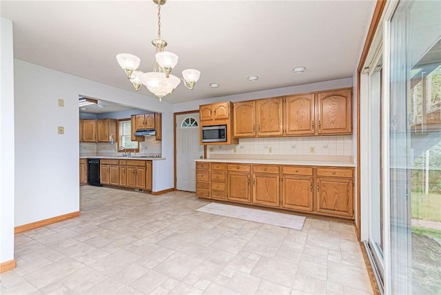 10 Joanth Ter, Westerly, RI 02891 - kitchen with stainless steel microwave, a chandelier, light countertops, and tasteful backsplash