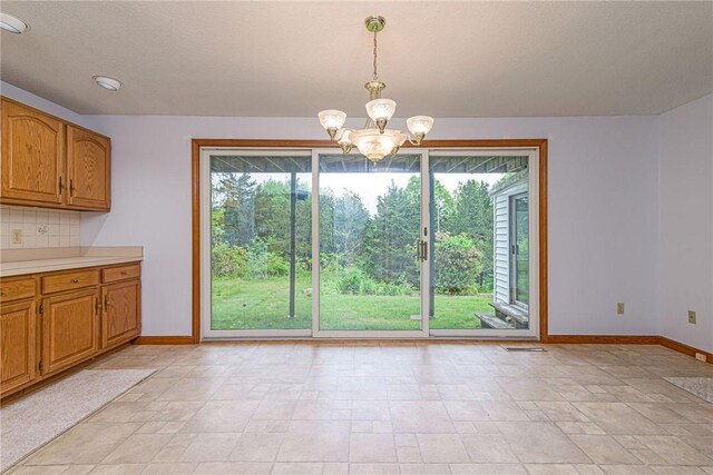 10 Joanth Ter, Westerly, RI 02891 - unfurnished dining area with baseboards, a chandelier, and light stone finish flooring