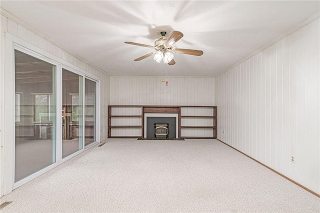 10 Joanth Ter, Westerly, RI 02891 - unfurnished living room with carpet floors, ceiling fan, ornamental molding, and a wood stove