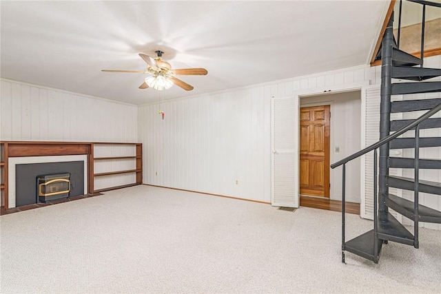 10 Joanth Ter, Westerly, RI 02891 - unfurnished living room with stairs, ceiling fan, carpet floors, baseboards, and wood walls