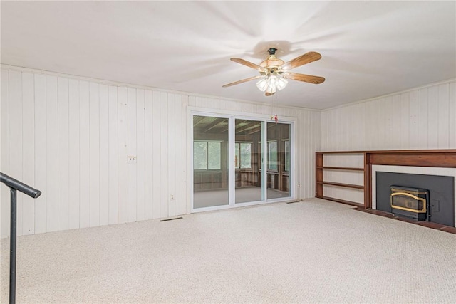 10 Joanth Ter, Westerly, RI 02891 - unfurnished living room featuring carpet, ceiling fan, and wood walls