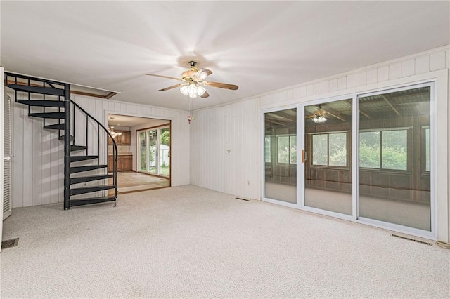 10 Joanth Ter, Westerly, RI 02891 - unfurnished living room with a ceiling fan, carpet, stairs, and wooden walls