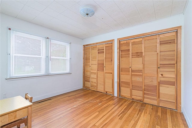 10 Joanth Ter, Westerly, RI 02891 - unfurnished bedroom featuring multiple closets and light wood-style flooring