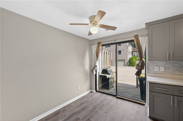 403 Pinewood Dr, Smithfield, RI 02917 - unfurnished dining area featuring light wood finished floors, a ceiling fan, and baseboards