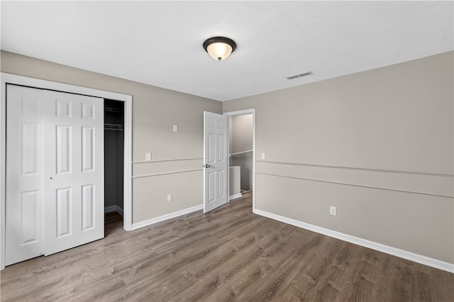 403 Pinewood Dr, Smithfield, RI 02917 - unfurnished bedroom with wood finished floors, a closet, and baseboards