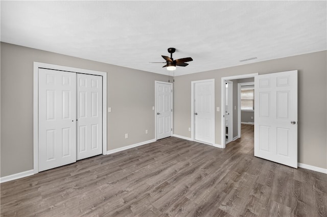 403 Pinewood Dr, Smithfield, RI 02917 - unfurnished bedroom featuring baseboards, wood finished floors, and a ceiling fan