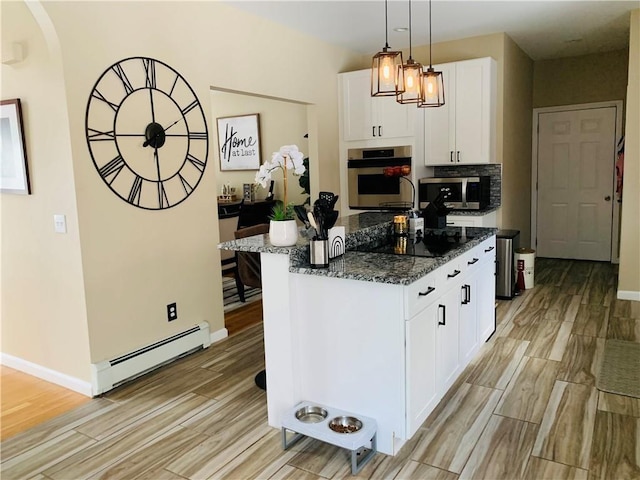 20 Canton Ct, Cranston, RI 02921 - kitchen with a baseboard heating unit, appliances with stainless steel finishes, light wood finished floors, and dark stone counters