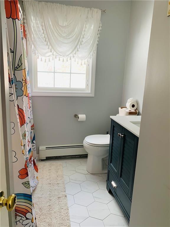 20 Canton Ct, Cranston, RI 02921 - full bathroom with a baseboard radiator, vanity, toilet, tile patterned flooring, and a shower with curtain