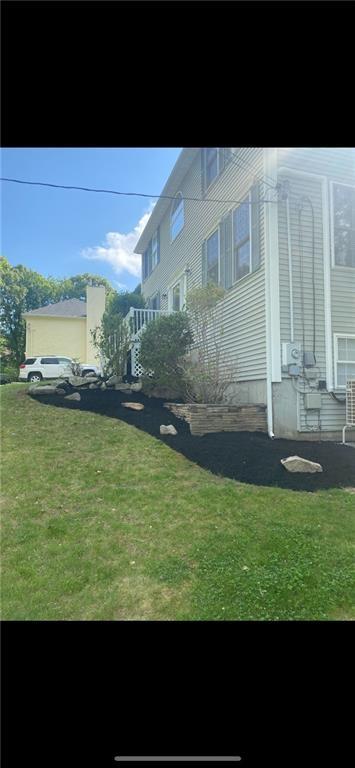 20 Canton Ct, Cranston, RI 02921 - view of side of home featuring a yard