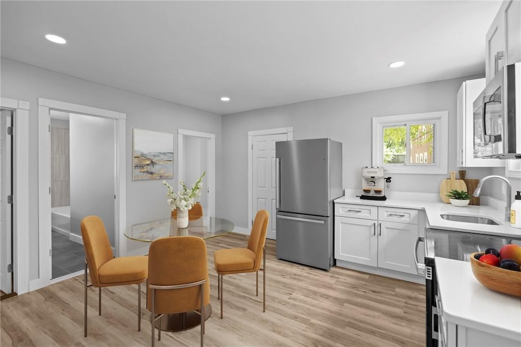 12 Spring St, West Warwick, RI 02893 - dining room featuring light wood-type flooring and recessed lighting