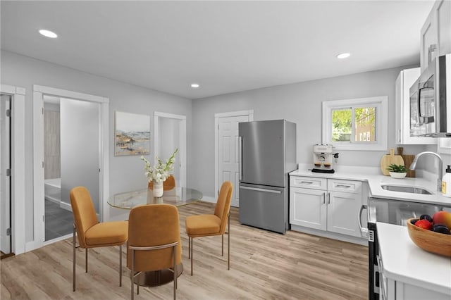 12 Spring St, West Warwick, RI 02893 - dining room featuring light wood-type flooring and recessed lighting