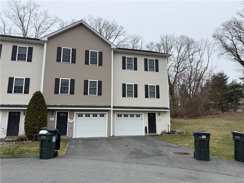 75 Esmond St Unit 5D, West Warwick, RI 02893 - view of property featuring asphalt driveway, an attached garage, and a front lawn