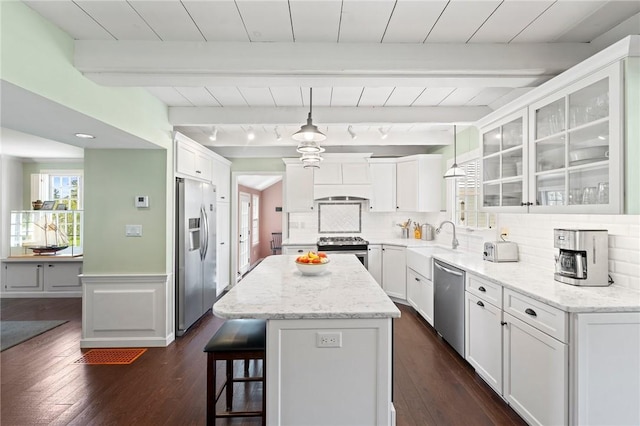 31 Peaceful Way, Tiverton, RI 02878 - kitchen featuring appliances with stainless steel finishes, dark wood-type flooring, white cabinets, a center island, and a wainscoted wall