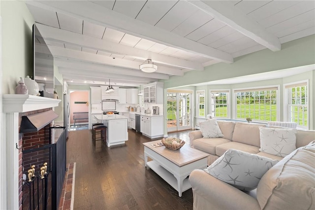 31 Peaceful Way, Tiverton, RI 02878 - living room with dark wood-style flooring, a brick fireplace, and beam ceiling