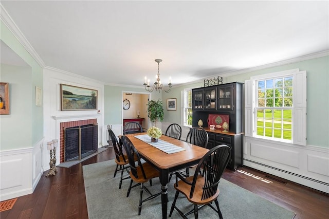 31 Peaceful Way, Tiverton, RI 02878 - dining area with a baseboard radiator, crown molding, a chandelier, a brick fireplace, and dark wood-style flooring