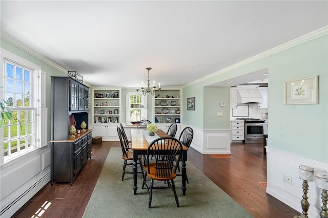 31 Peaceful Way, Tiverton, RI 02878 - dining space with a baseboard radiator, a chandelier, dark wood-style flooring, crown molding, and built in features