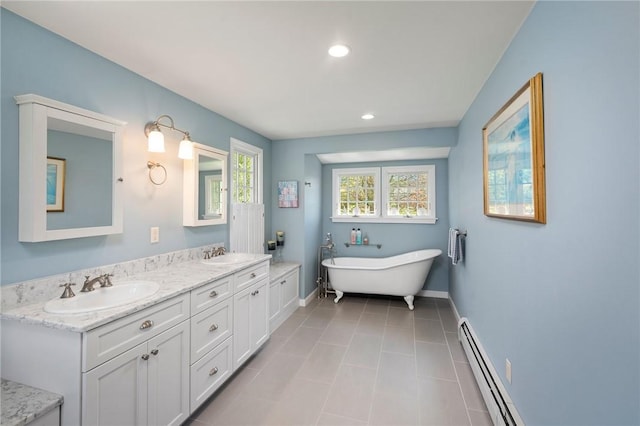 31 Peaceful Way, Tiverton, RI 02878 - bathroom with a baseboard heating unit, double vanity, baseboards, a freestanding bath, and recessed lighting