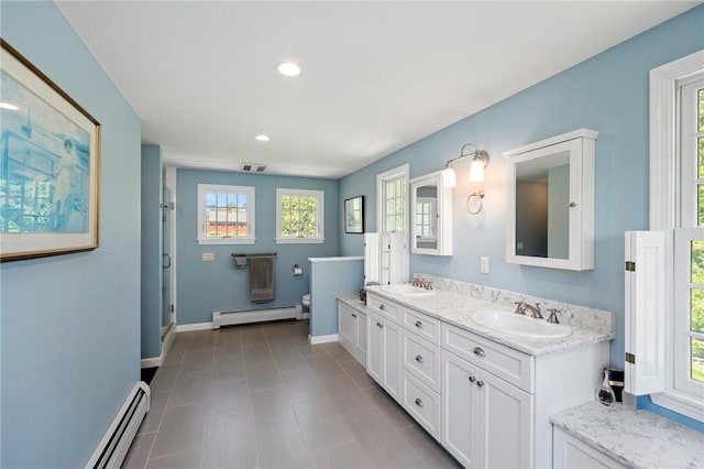 31 Peaceful Way, Tiverton, RI 02878 - full bath featuring a baseboard heating unit, double vanity, a stall shower, toilet, and recessed lighting