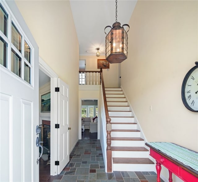 31 Peaceful Way, Tiverton, RI 02878 - stairway with a high ceiling, stone finish flooring, baseboards, and a chandelier