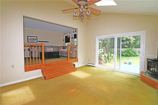 23 Sherman Ln, Middletown, RI 02842 - unfurnished living room featuring baseboard heating, carpet flooring, ceiling fan, a wood stove, and vaulted ceiling