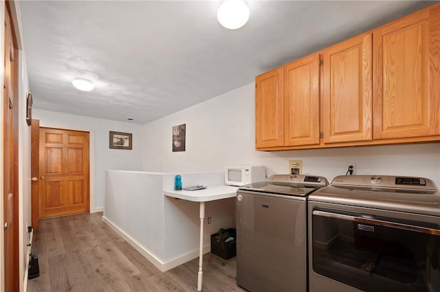 350 Austin Farm Rd, Exeter, RI 02822 - laundry room with cabinet space, washing machine and dryer, light wood-style flooring, and baseboards