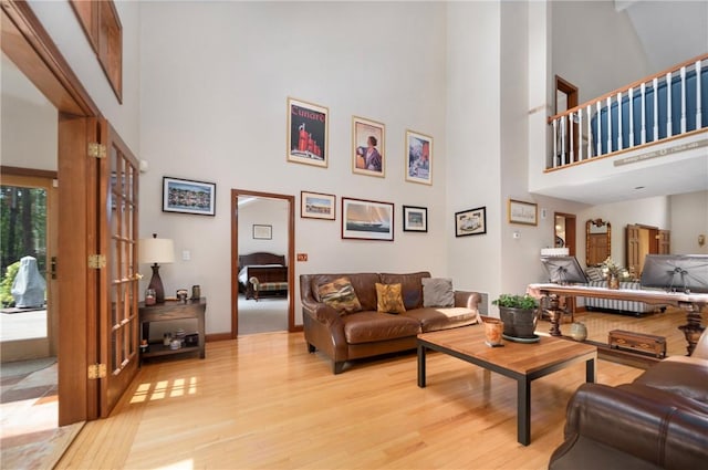 350 Austin Farm Rd, Exeter, RI 02822 - living room featuring a towering ceiling, light wood-style floors, and baseboards