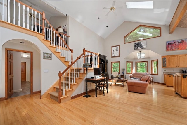 350 Austin Farm Rd, Exeter, RI 02822 - living area featuring high vaulted ceiling, arched walkways, light wood-style floors, stairway, and ceiling fan
