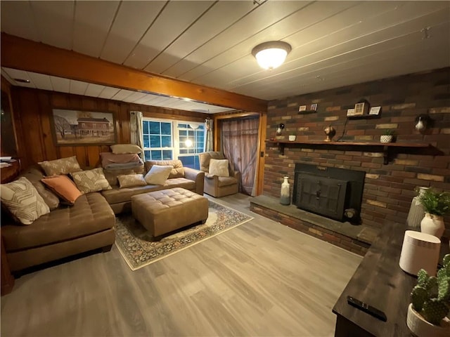 16 Bunny Trl, Scituate, RI 02831 - living room with wood finished floors, wood walls, a brick fireplace, and beamed ceiling