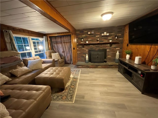 16 Bunny Trl, Scituate, RI 02831 - living area with wooden walls, wood finished floors, and a brick fireplace