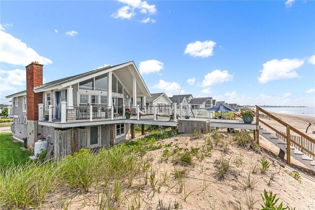 413 Atlantic Ave, Westerly, RI 02891 - rear view of property with a chimney and a deck with water view