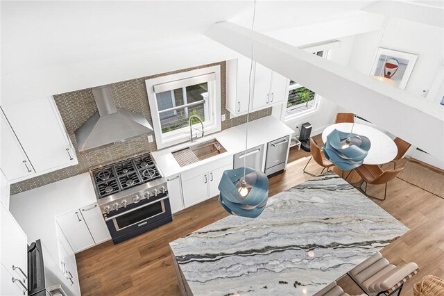 413 Atlantic Ave, Westerly, RI 02891 - kitchen with wall chimney range hood, wood finished floors, a sink, and white cabinets