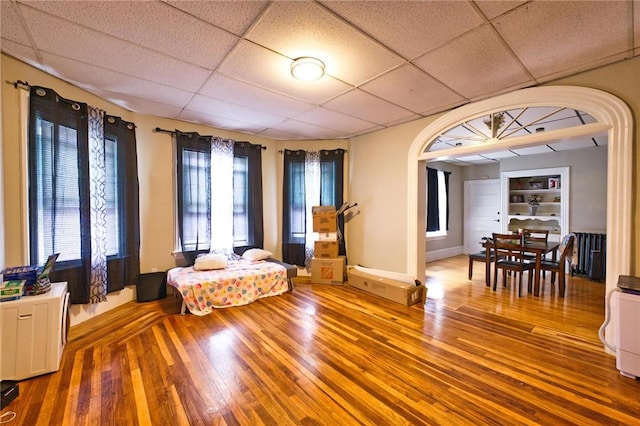 62 School St, Fall River, MA 02720 - living area with wood finished floors, a drop ceiling, and baseboards