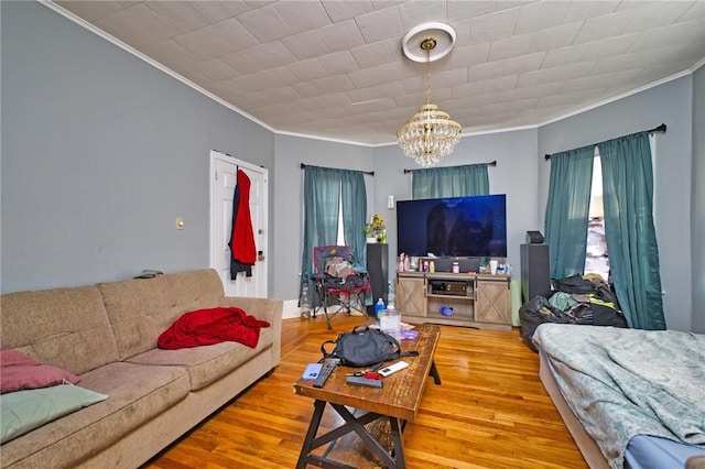 62 School St, Fall River, MA 02720 - living area featuring crown molding, a chandelier, and wood finished floors