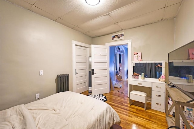62 School St, Fall River, MA 02720 - bedroom featuring radiator heating unit, a paneled ceiling, and wood finished floors