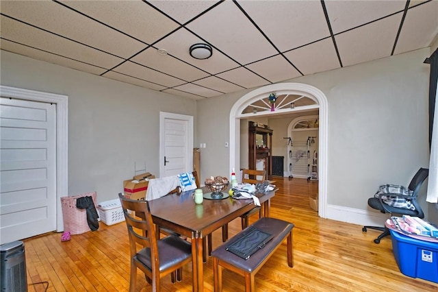 62 School St, Fall River, MA 02720 - dining area with light wood-type flooring, arched walkways, a drop ceiling, and baseboards