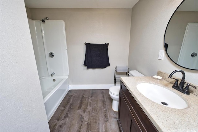 62 School St, Fall River, MA 02720 - full bath featuring wood finished floors, toilet, vanity, bathing tub / shower combination, and baseboards