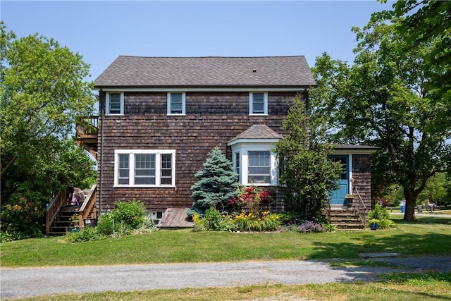 201 Paradise Ave, Middletown, RI 02842 - view of front facade featuring stairway, a front yard, a shingled roof, and a balcony