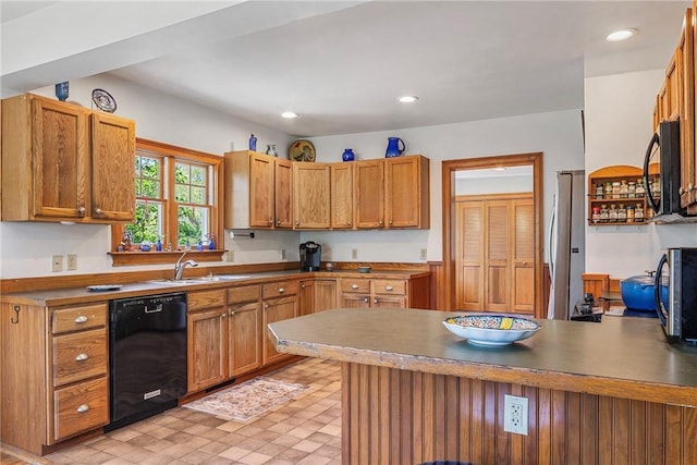 201 Paradise Ave, Middletown, RI 02842 - kitchen with black appliances, a peninsula, a sink, recessed lighting, and brown cabinets