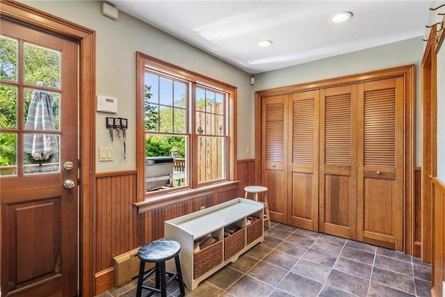201 Paradise Ave, Middletown, RI 02842 - doorway to outside featuring wainscoting, wood walls, recessed lighting, and dark tile patterned floors