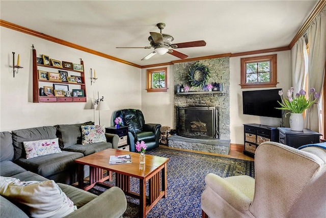 201 Paradise Ave, Middletown, RI 02842 - living room featuring ornamental molding, healthy amount of natural light, a stone fireplace, a ceiling fan, and wood finished floors