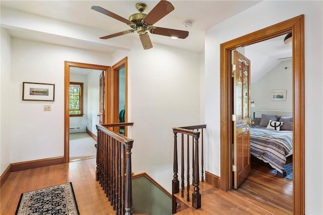 201 Paradise Ave, Middletown, RI 02842 - corridor featuring an upstairs landing, light wood-style flooring, baseboard heating, lofted ceiling, and baseboards
