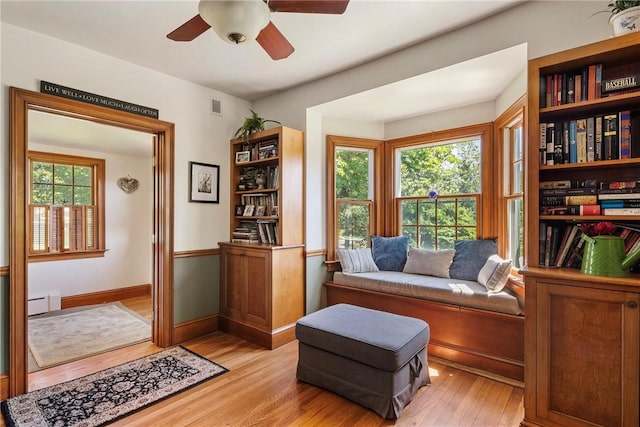 201 Paradise Ave, Middletown, RI 02842 - sitting room with light wood-style floors, ceiling fan, baseboards, and a baseboard heating unit