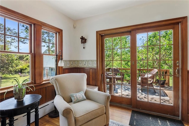 201 Paradise Ave, Middletown, RI 02842 - sitting room featuring wood finished floors, wainscoting, a baseboard radiator, and wood walls