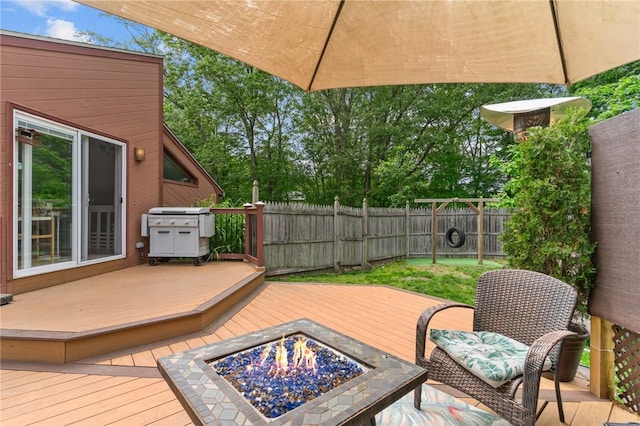 68 Everglade Ave, Warwick, RI 02886 - wooden terrace featuring an outdoor fire pit, a fenced backyard, and grilling area
